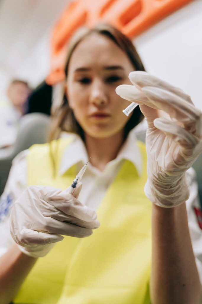 Maximizing Your Blog’s Reach: SEO Tips for Bloggers 2 A focused female paramedic prepares a syringe inside an ambulance, showcasing emergency medical care.