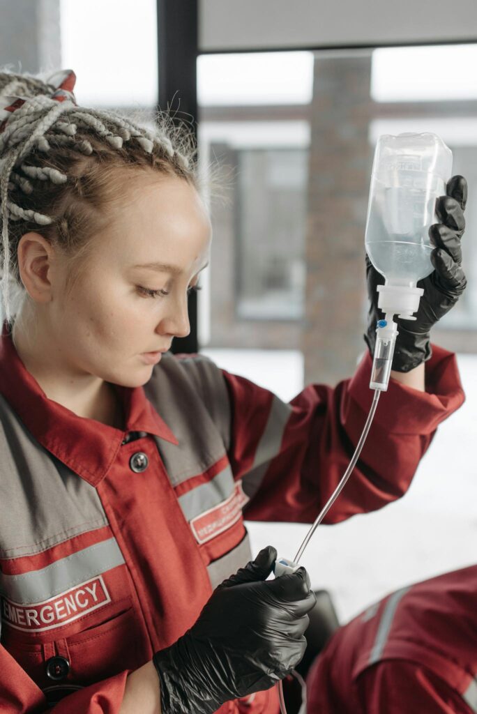Building a Loyal Blog Audience: Strategies for Engagement and Growth 2 Female paramedic in red uniform preparing an IV drip for emergency medical care.