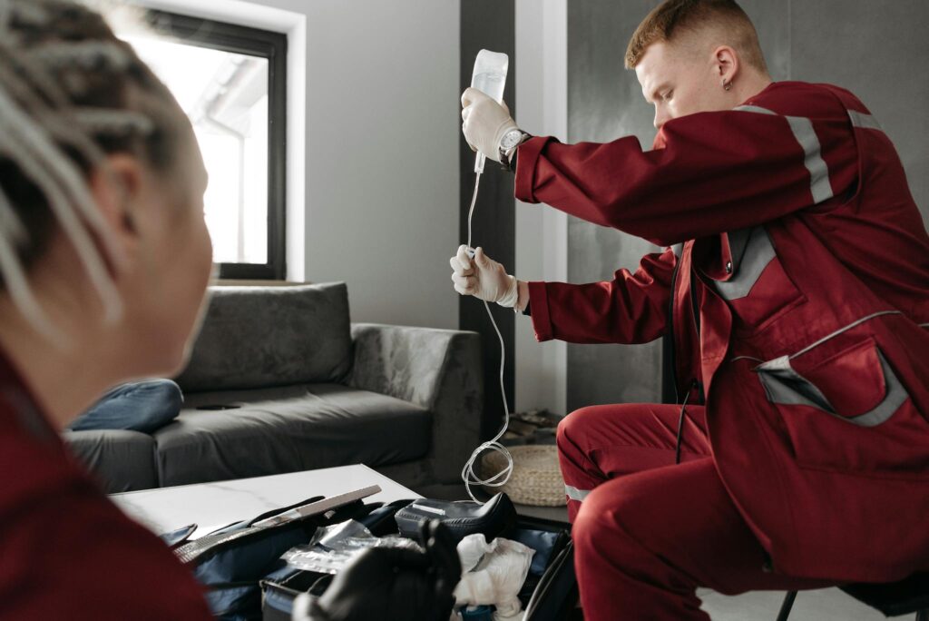 Effective Blog Promotion: Strategies to Increase Your Reach 2 Paramedic providing intravenous therapy to a patient at home for emergency medical care.